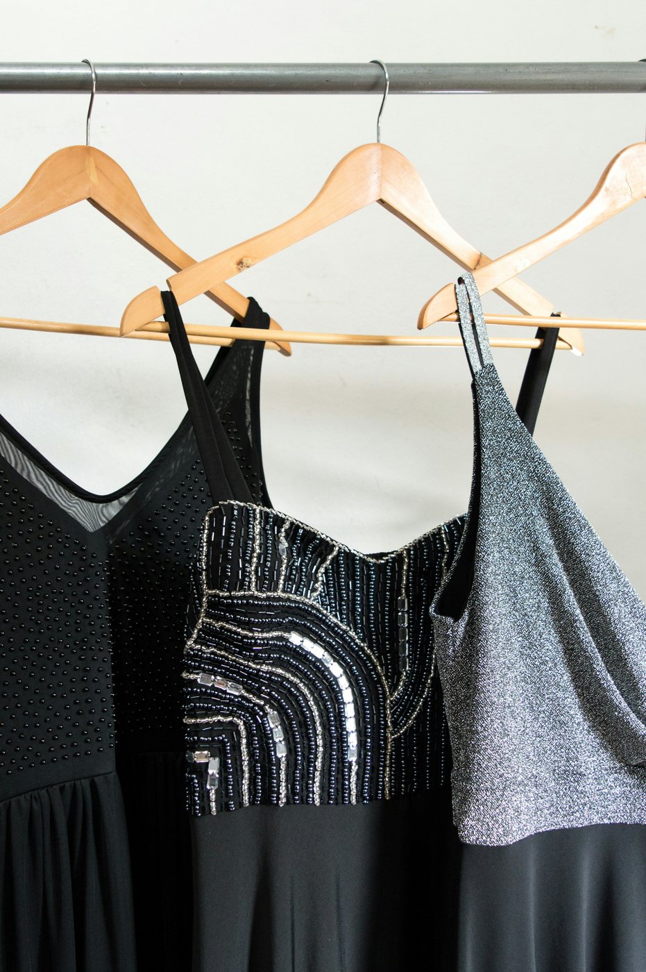 Black and white dresses hanging together on a swing.